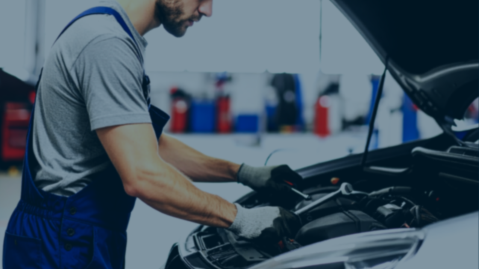 Vehicle technician working on a car engine in a Cardiff workshop